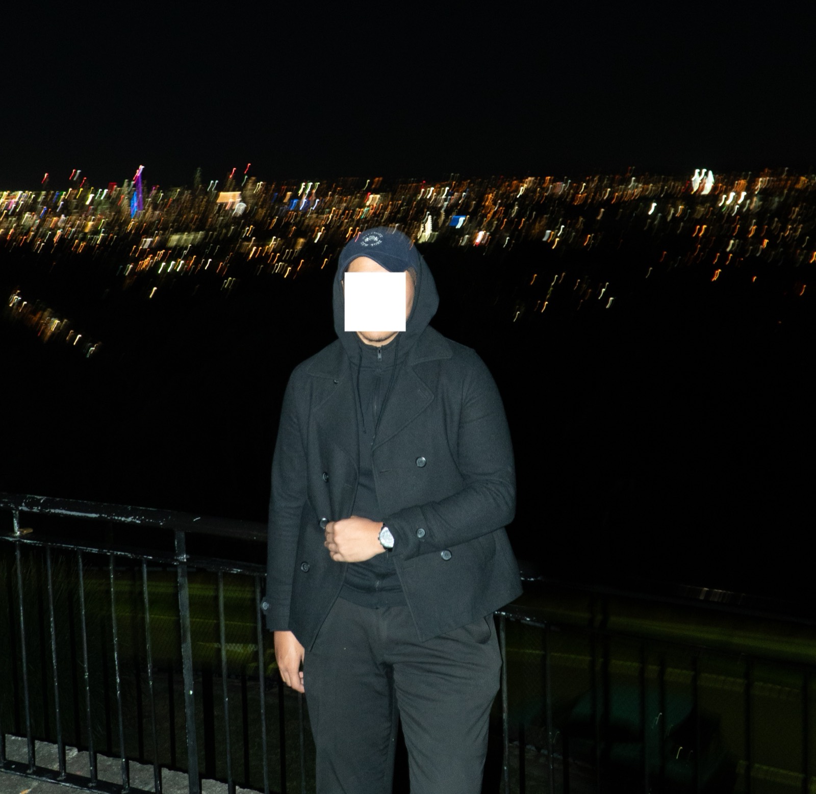Zach at a lookout over city lights at night